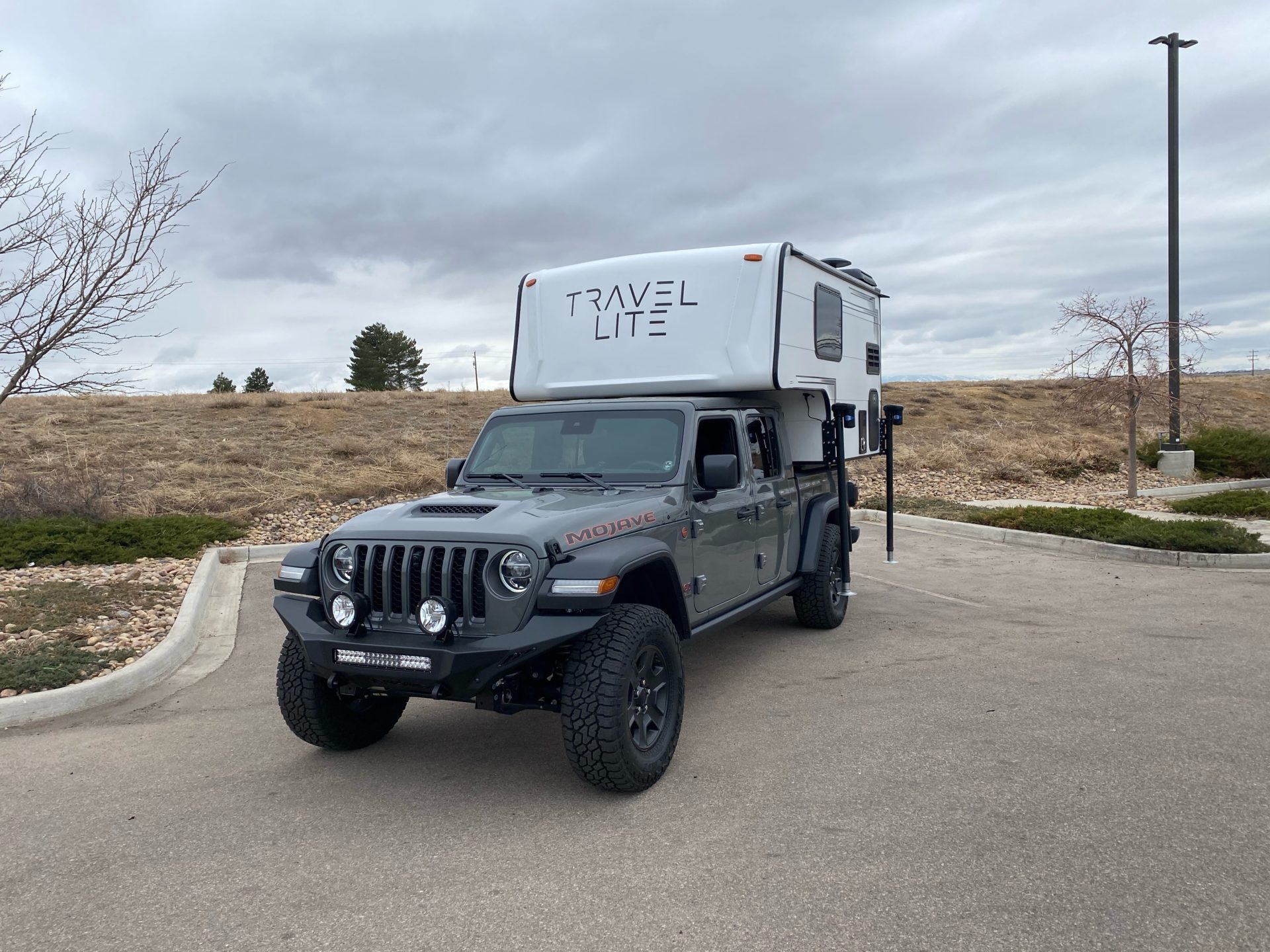 JEEP TRUCK WITH TRAVEL LITE TRUCK CAMPER ON THE BACK